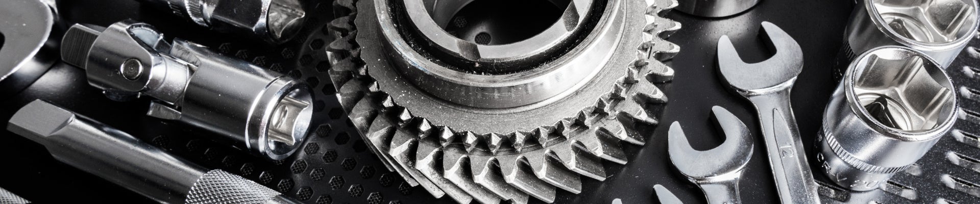 Automotive repair tools, wrenches, sockets, and metal gears.